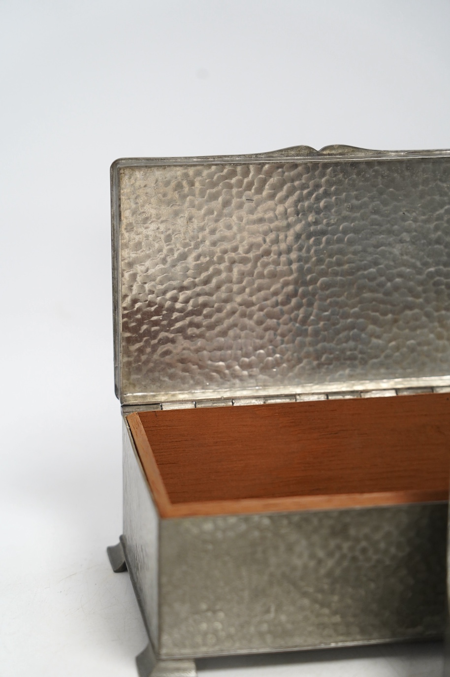 Two pewter cigarette boxes including a Liberty Tudric hammered form, largest 17.5cm wide. Condition - good